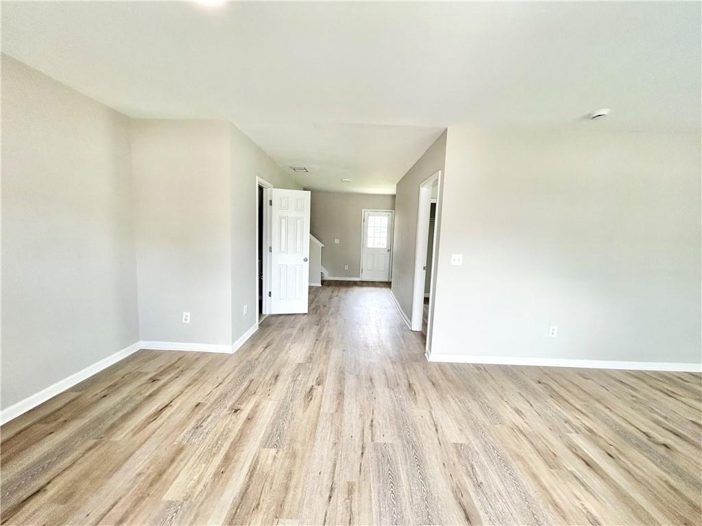 736 Wheel House Lane, Unit B Monroe, GA 30655 - Photo 5 of 15 a view of a room with wooden floor and a toilet