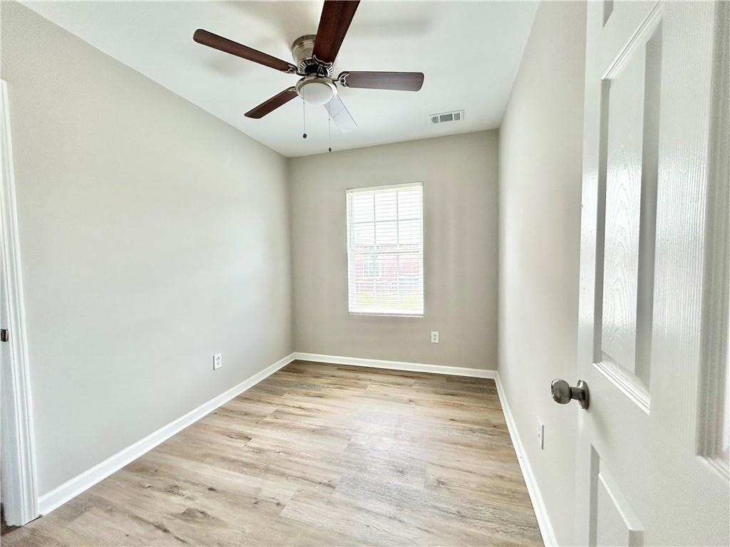 736 Wheel House Lane, Unit B Monroe, GA 30655 - Photo 10 of 15 wooden floor in an empty room with a window