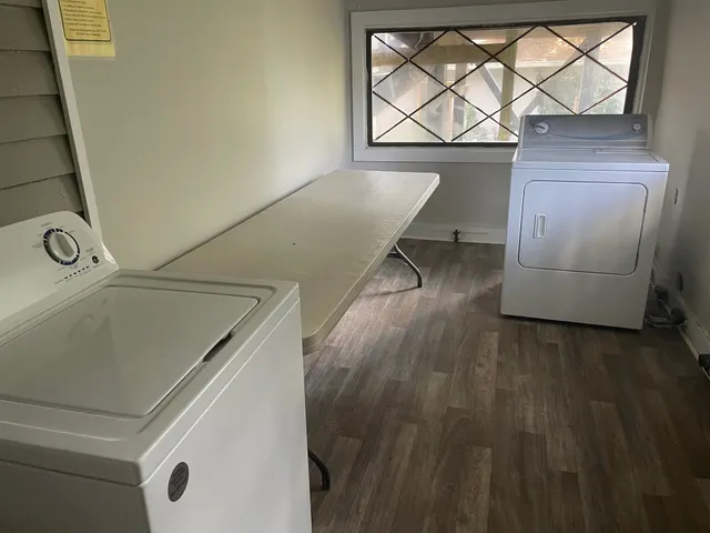 a view of a room with wooden floor and windows