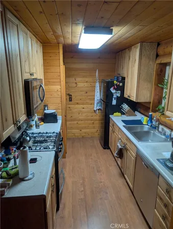 a kitchen with sink cabinets and a stove