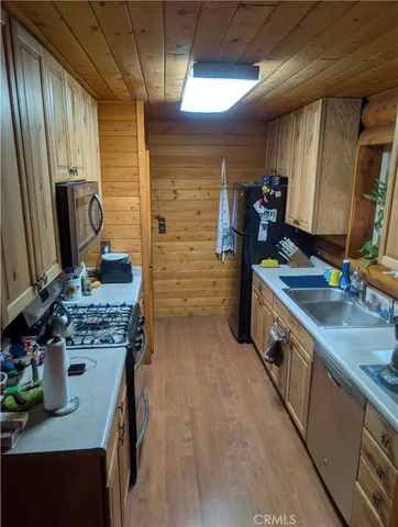 a kitchen with sink cabinets and a stove