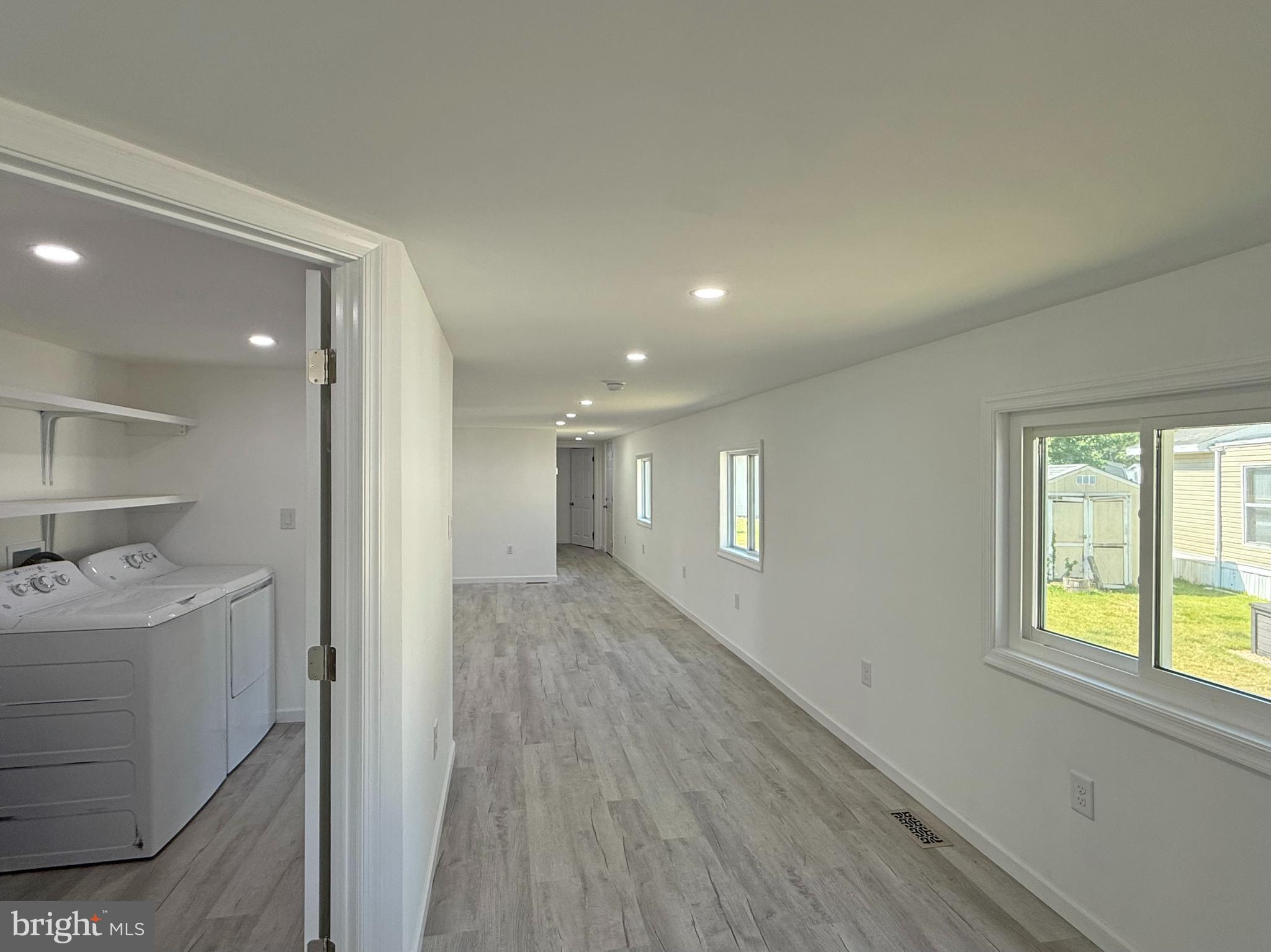 33308 Lighthouse Court, Unit D18 Lewes, DE 19958 - Photo 13 of 39 a view of hallway with a window and wooden floor