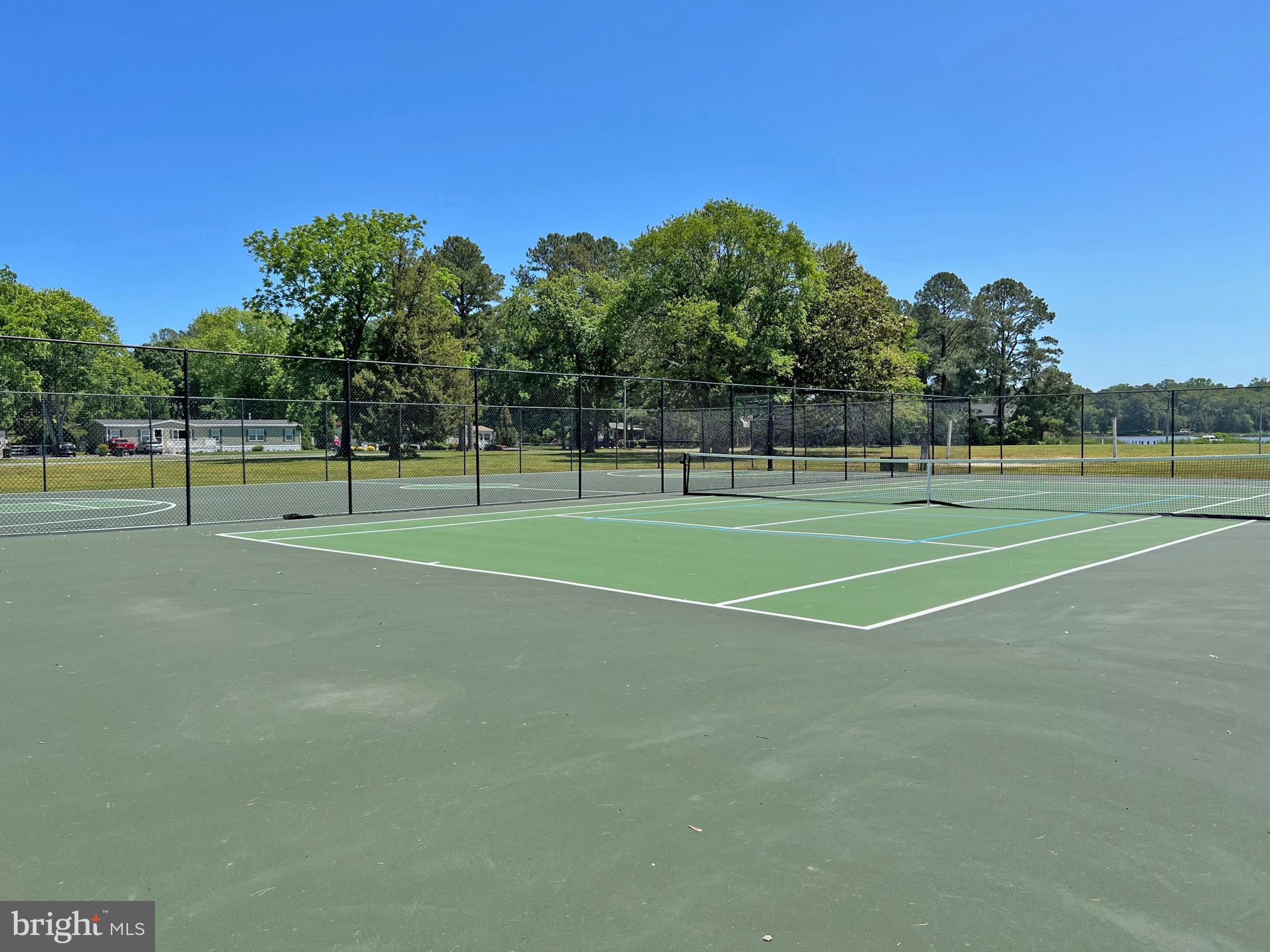 33308 Lighthouse Court, Unit D18 Lewes, DE 19958 - Photo 38 of 39 a view of a tennis ground with large trees