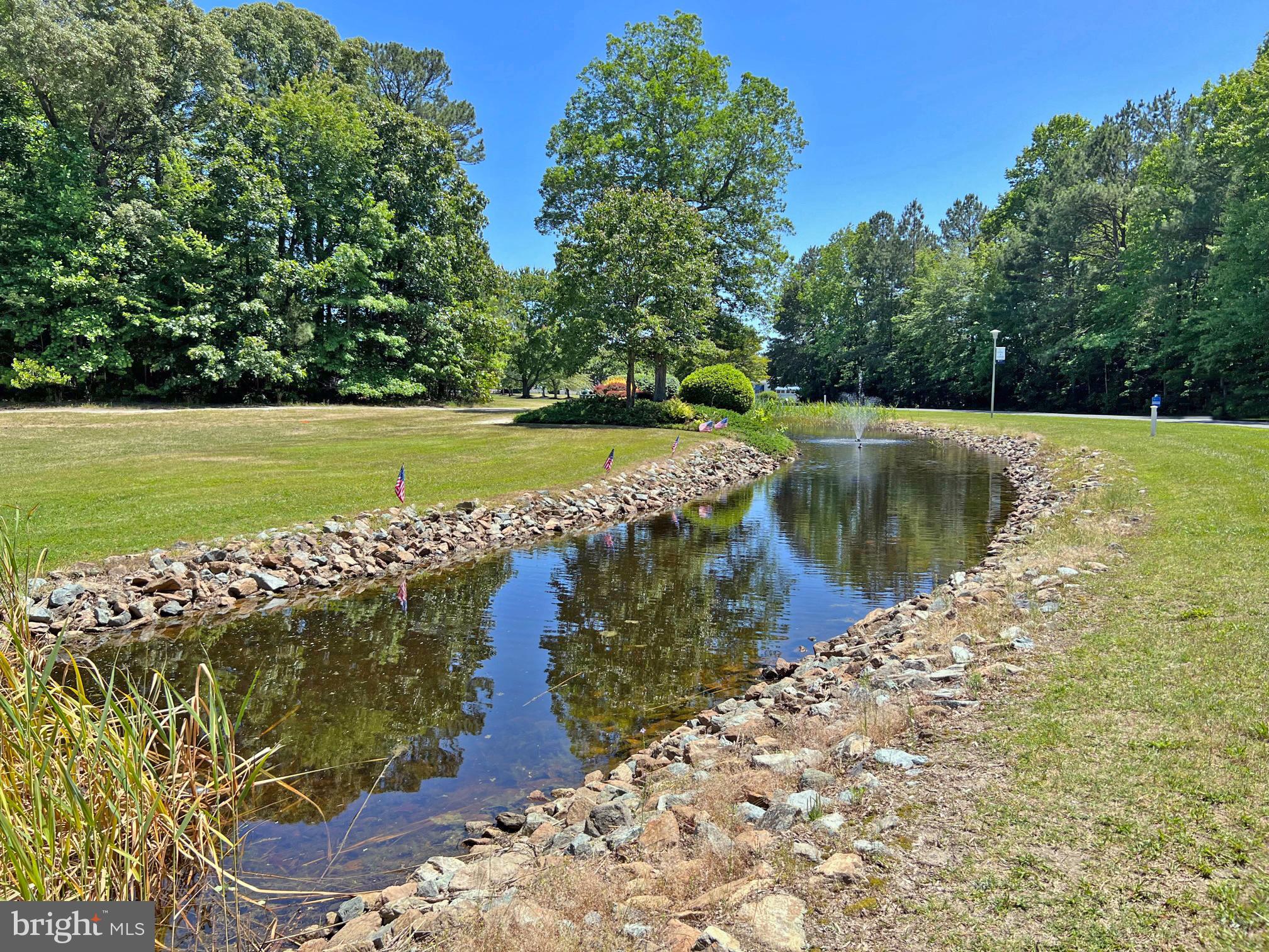 33308 Lighthouse Court, Unit D18 Lewes, DE 19958 - Photo 39 of 39 a view of a lake with a yard