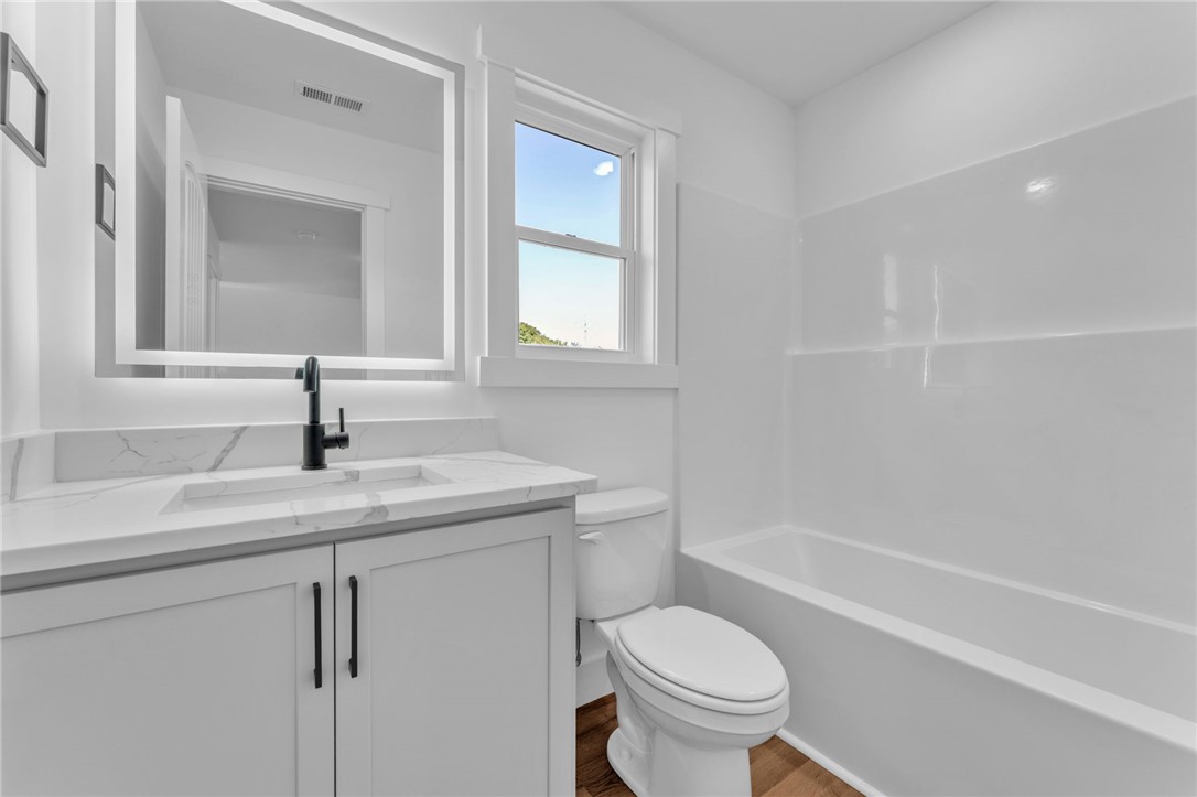 1723 Harris Bridge Road Anderson, SC 29621 - Photo 25 of 33 A well-appointed bathroom with a modern vanity, a sleek tub, and sun-filled natural light.