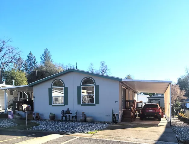 a front view of house with yard outdoor seating and barbeque oven