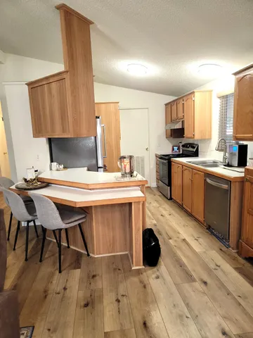 a kitchen with a refrigerator and a sink