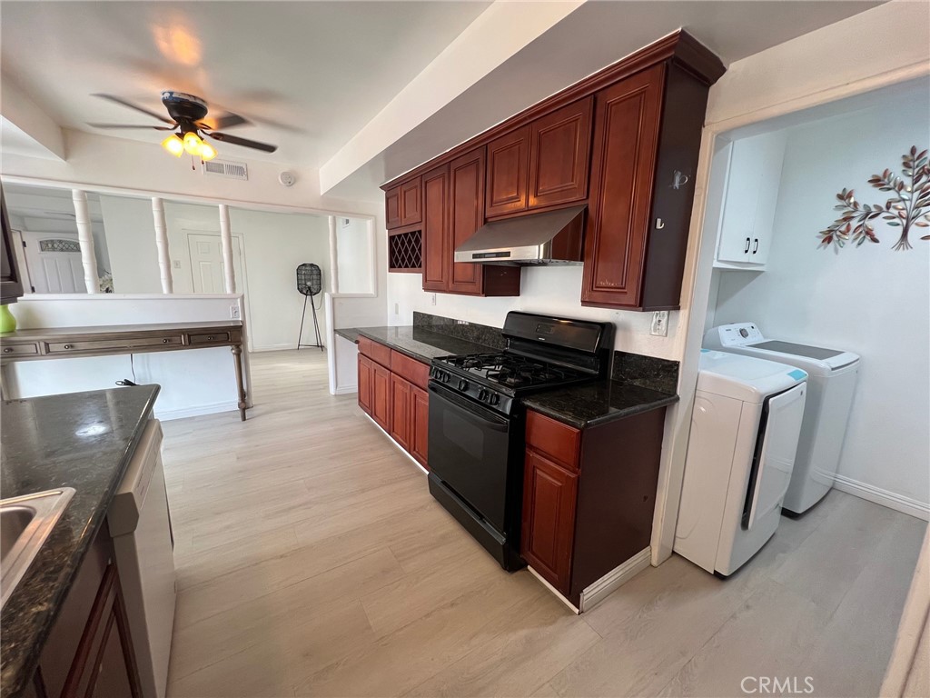 601 Camino Grove Avenue Arcadia, CA 91006 - Photo 3 of 15 a kitchen with stainless steel appliances granite countertop a stove a sink and a microwave
