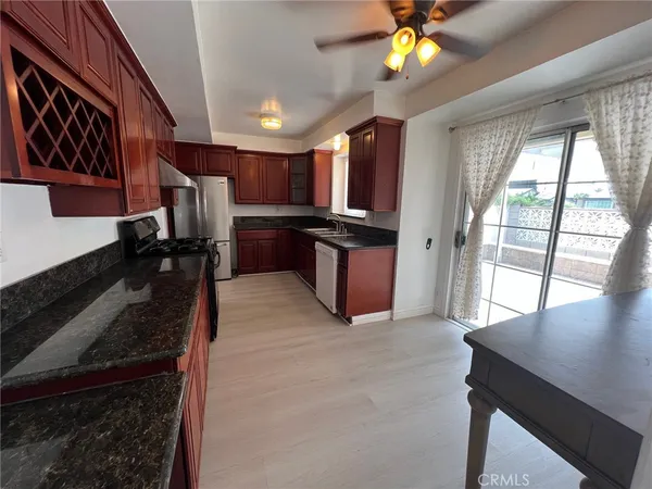 a view of kitchen with refrigerator stove dining table and chairs