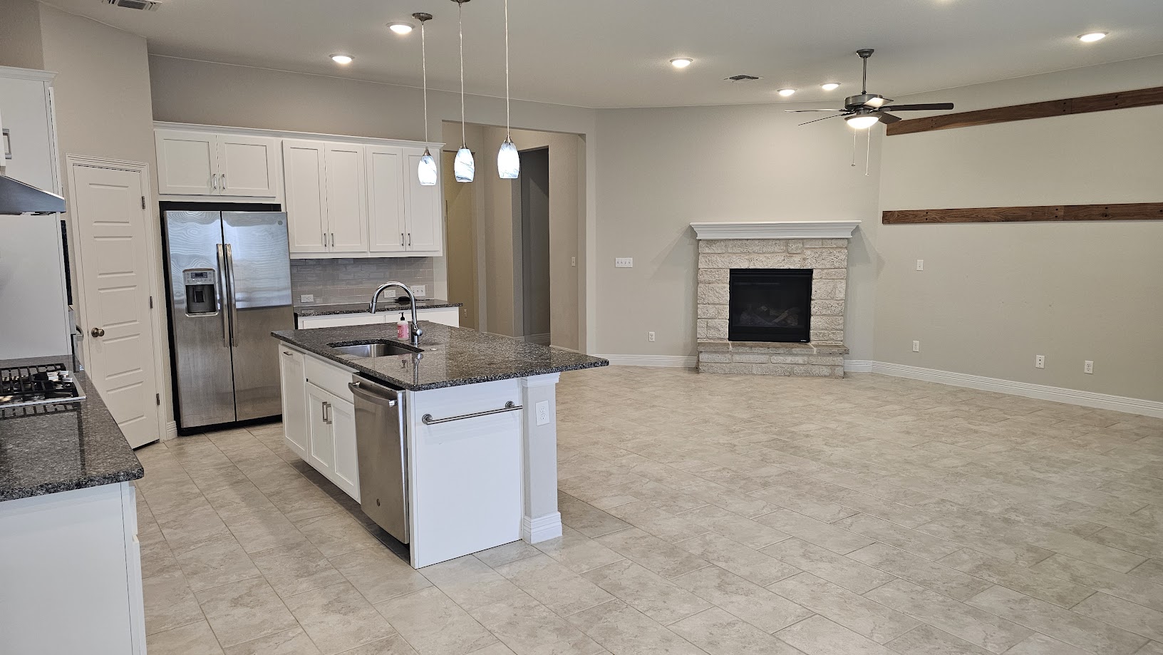 712 Muster Bend Georgetown, TX 78626 - Photo 26 of 26 Kitchen with white cabinetry, appliances with stainless steel finishes, open floor plan, and a sink
