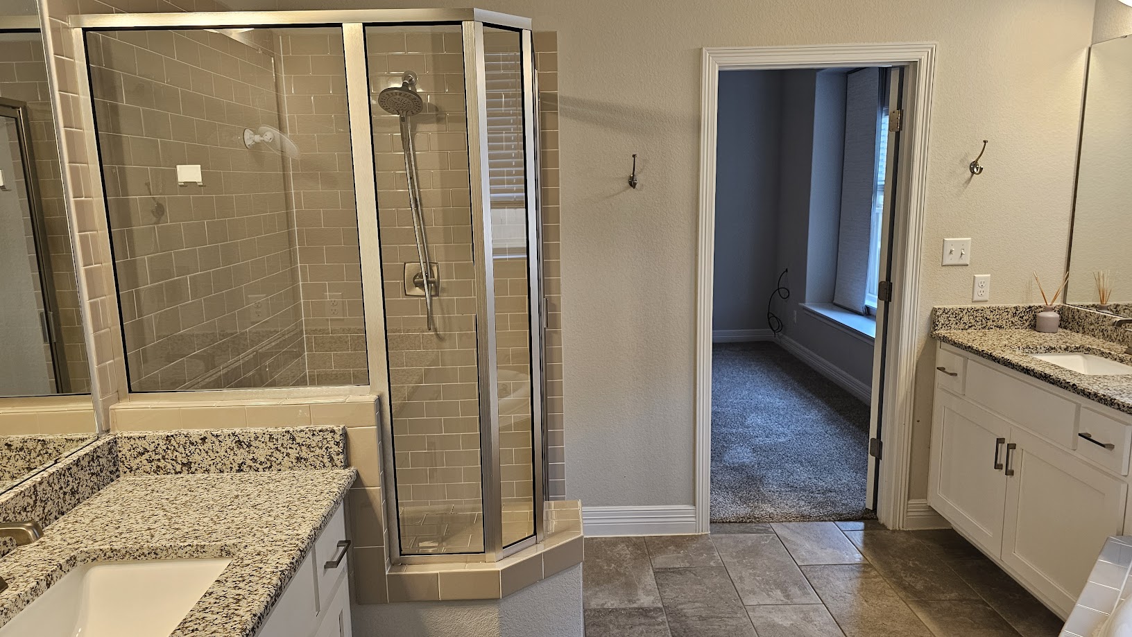 712 Muster Bend Georgetown, TX 78626 - Photo 11 of 26 Bathroom with a stall shower, baseboards, two vanities, and a sink