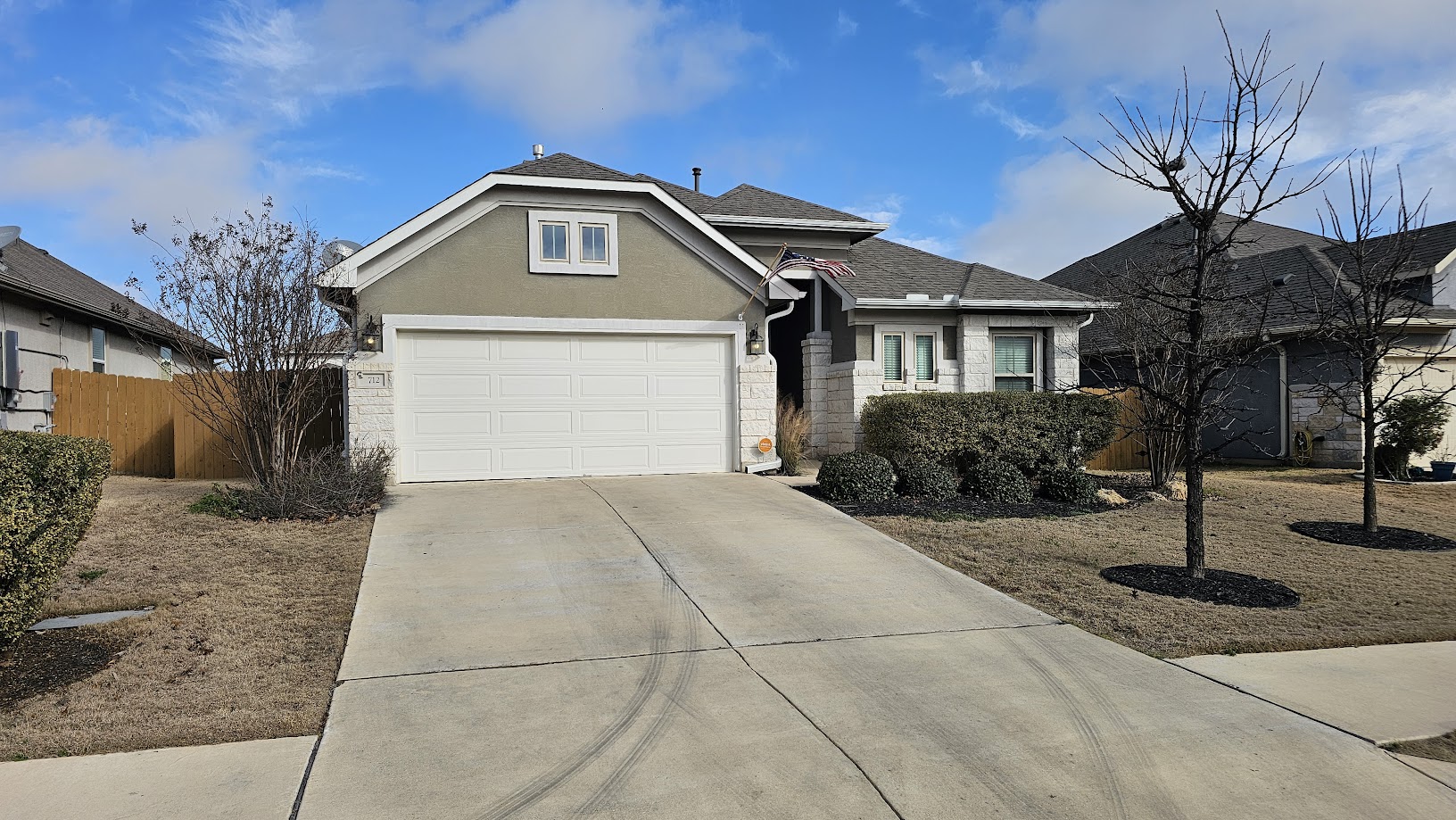 712 Muster Bend Georgetown, TX 78626 - Photo 20 of 26 View of front of home featuring stucco siding, fence, a garage, stone siding, and driveway