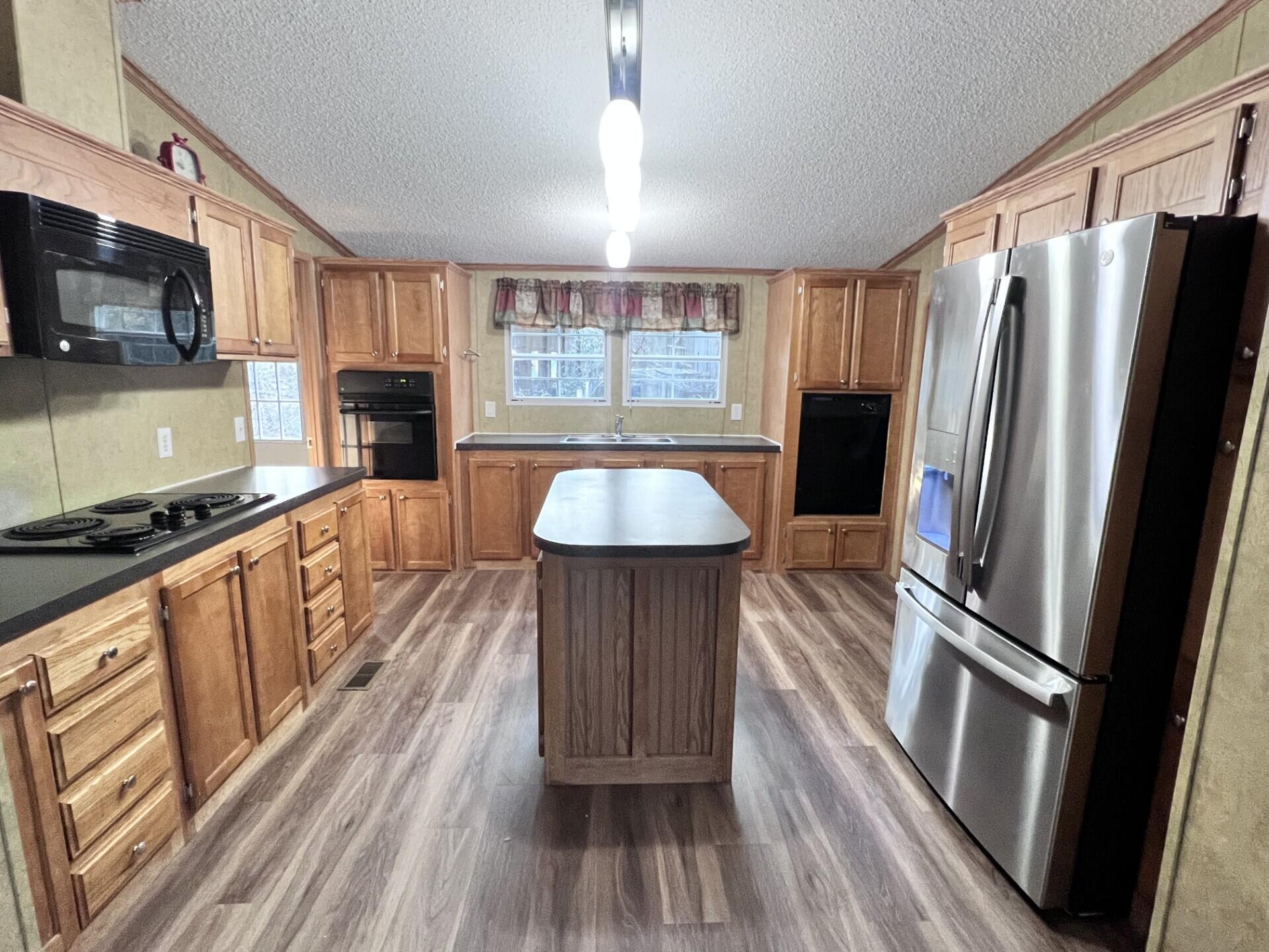 4309 Rebecca Road Crestview, FL 32539 - Photo 3 of 4 a kitchen with granite countertop a refrigerator stove and microwave