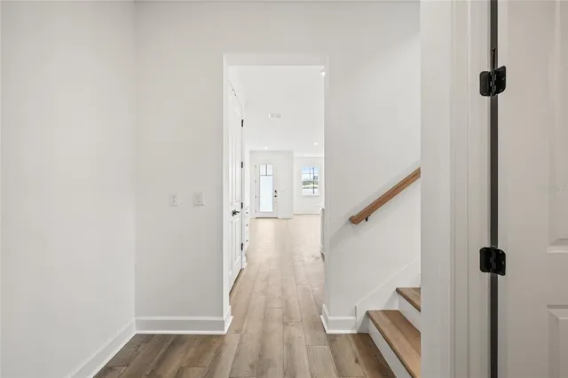 a view of a hallway with wooden floor