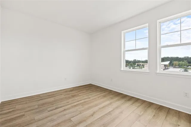 a view of room with wooden floor
