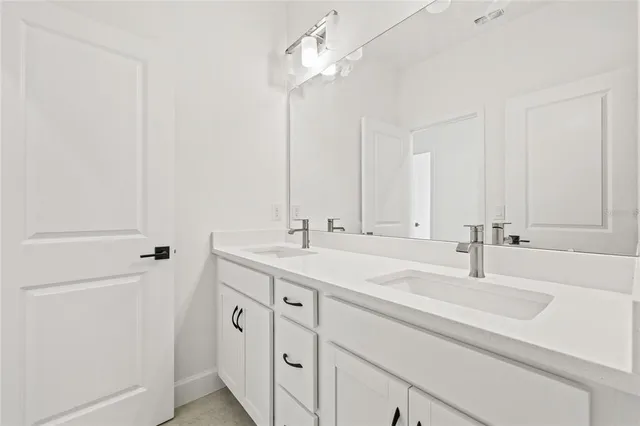 a bathroom with a double vanity sink toilet a shower and a bathtub