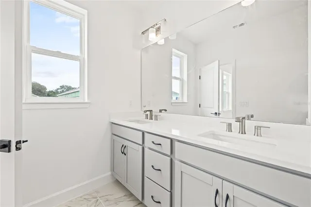 a bathroom with a shower sink and mirror