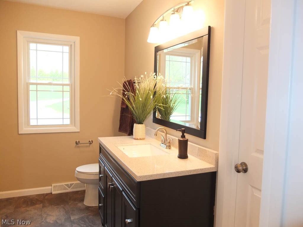 1475 Sand Run Road Akron, OH 44313 - Photo 12 of 24 Updated full bath with built-ins, new vanity, tile flooring and tile shower surround.