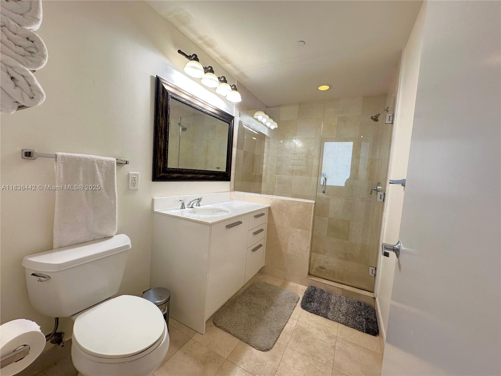 1050 Brickell Avenue, Unit 2220 Miami, FL 33131 - Photo 13 of 20 a bathroom with a toilet sink and mirror