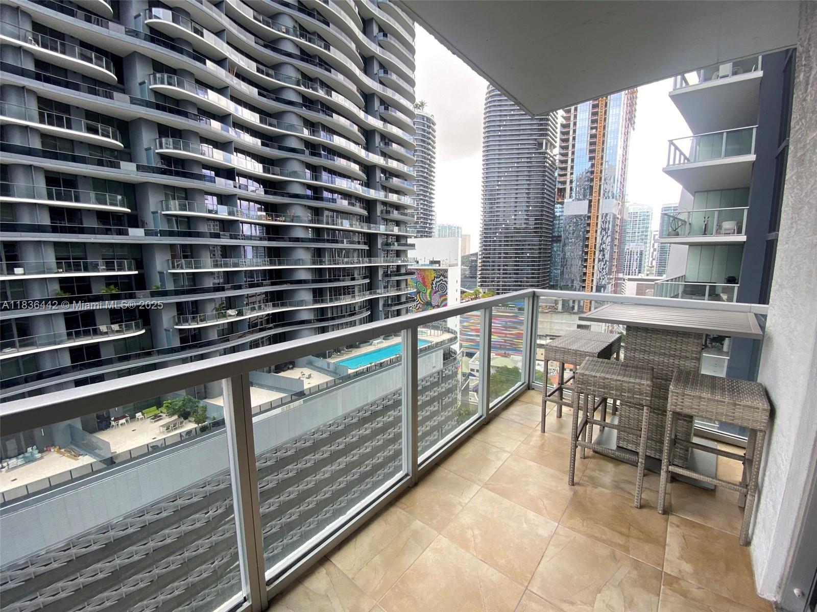 1050 Brickell Avenue, Unit 2220 Miami, FL 33131 - Photo 17 of 20 a view of a balcony with chairs