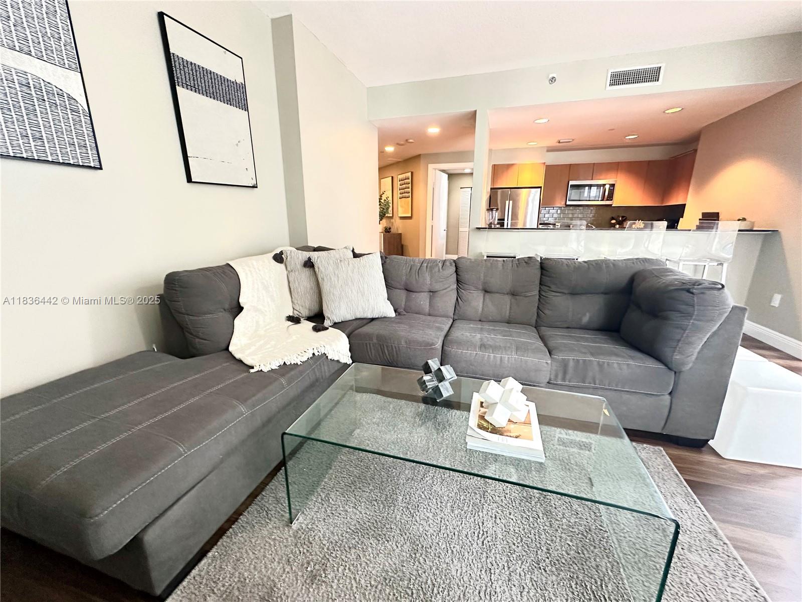 1050 Brickell Avenue, Unit 2220 Miami, FL 33131 - Photo 20 of 20 a living room with furniture and a wooden floor