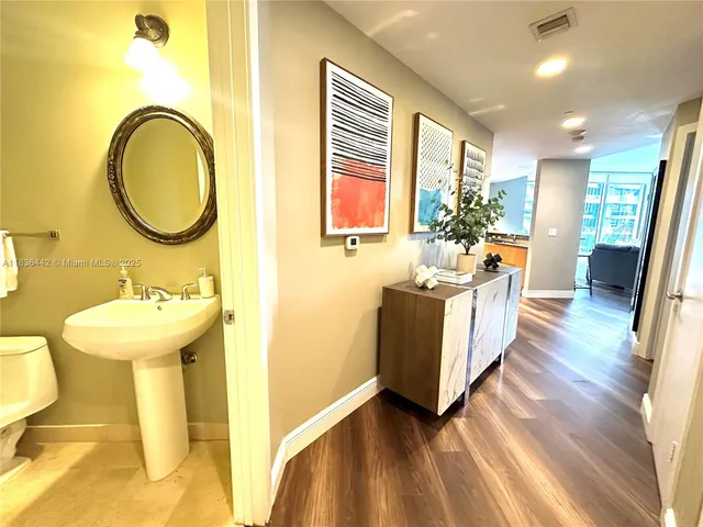 a bathroom with a sink mirror and a bathtub