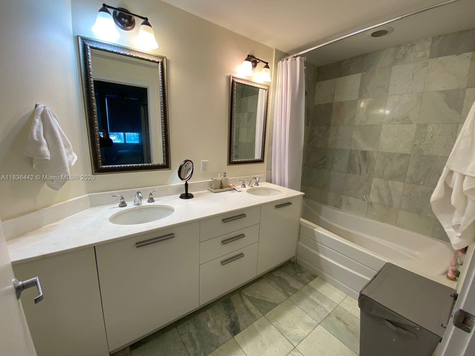 1050 Brickell Avenue, Unit 2220 Miami, FL 33131 - Photo 8 of 20 a bathroom with a double vanity sink mirror and bathtub