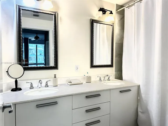 a bathroom with a double vanity sink mirror and