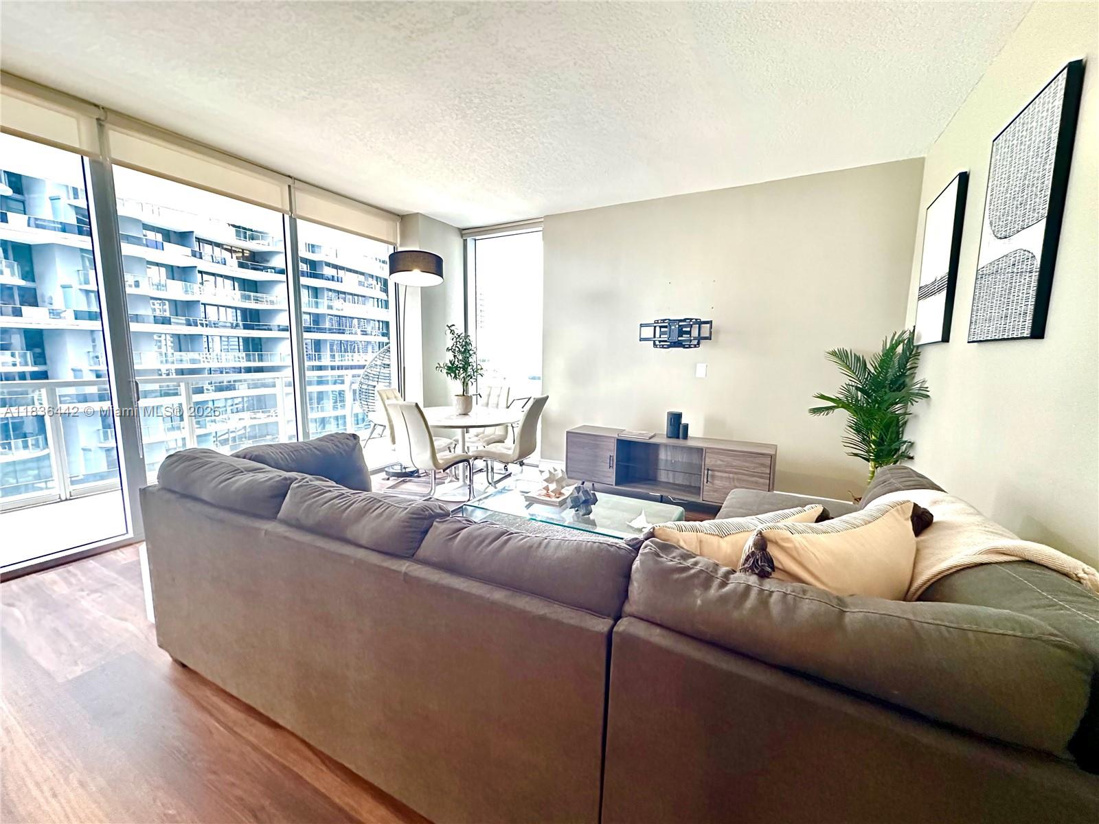 1050 Brickell Avenue, Unit 2220 Miami, FL 33131 - Photo 10 of 20 a living room with furniture and a large window
