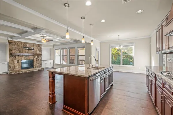 a kitchen with a stove and a wooden floor