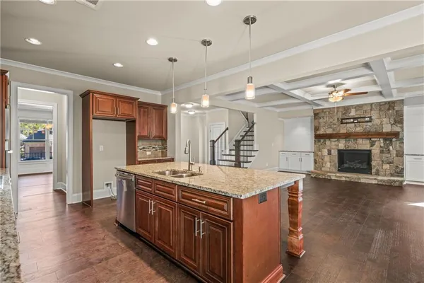 a kitchen with a stove and a wooden floor