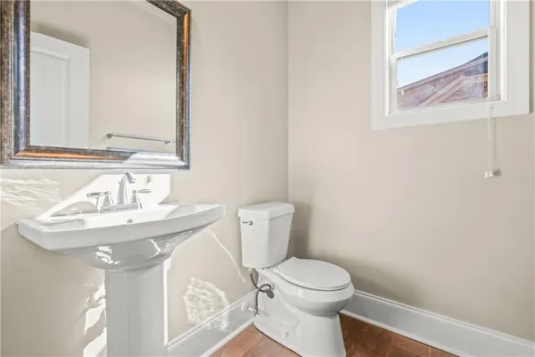 a bathroom with a sink a toilet and mirror