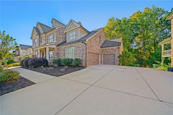 a front view of a house with a yard and a garage