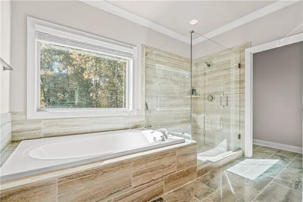 a spacious bathroom with a tub and shower