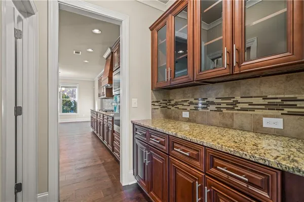 a kitchen with stainless steel appliances granite countertop a sink and dishwasher a oven with wooden cabinets