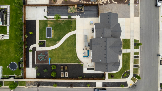 500 North 516th Street West, Unit 19 Mapleton, UT 84664 - Photo 34 of 41 Multi-gabled roofline, concrete pathways, manicured green lawns, and planted garden beds.
