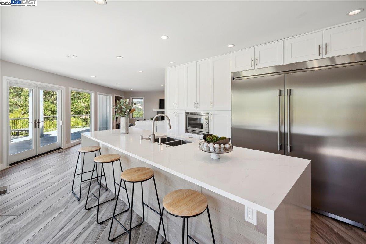 325 Bollinger Estates Court San Ramon, CA 94583 - Photo 14 of 59 a kitchen with stainless steel appliances a dining table chairs and wooden floor