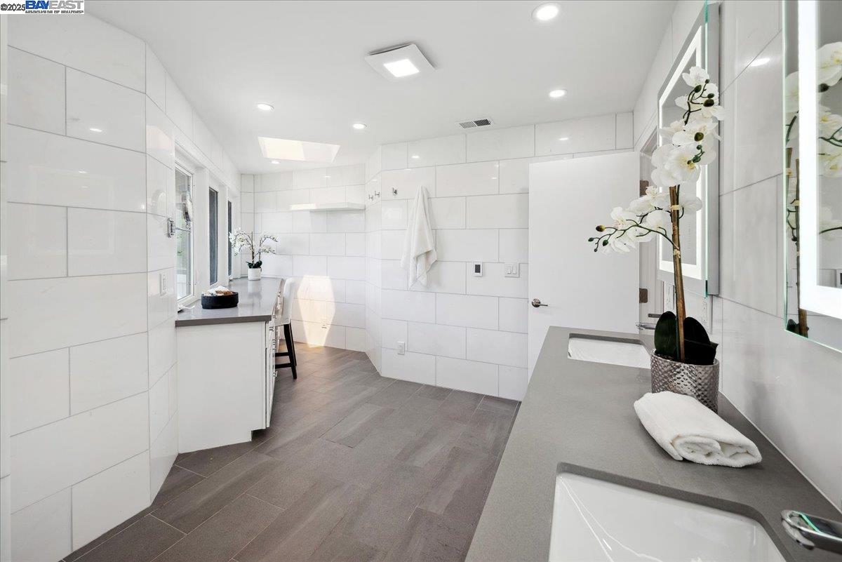 325 Bollinger Estates Court San Ramon, CA 94583 - Photo 31 of 59 a kitchen with white cabinets and wooden floor