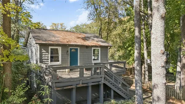 a view of house with backyard space and seating