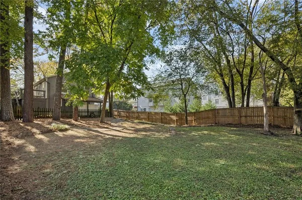 a view of a yard with large trees