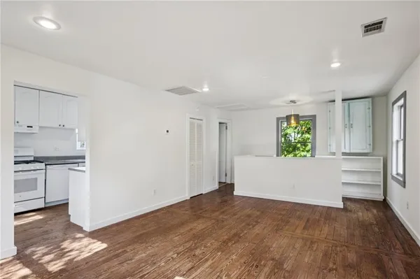 a view of kitchen with wooden floor and electronic appliances