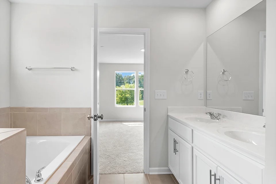 2456 Beverly Gail Road Pleasant View, TN 37146 - Photo 27 of 38 a bathroom with a tub sink and mirror