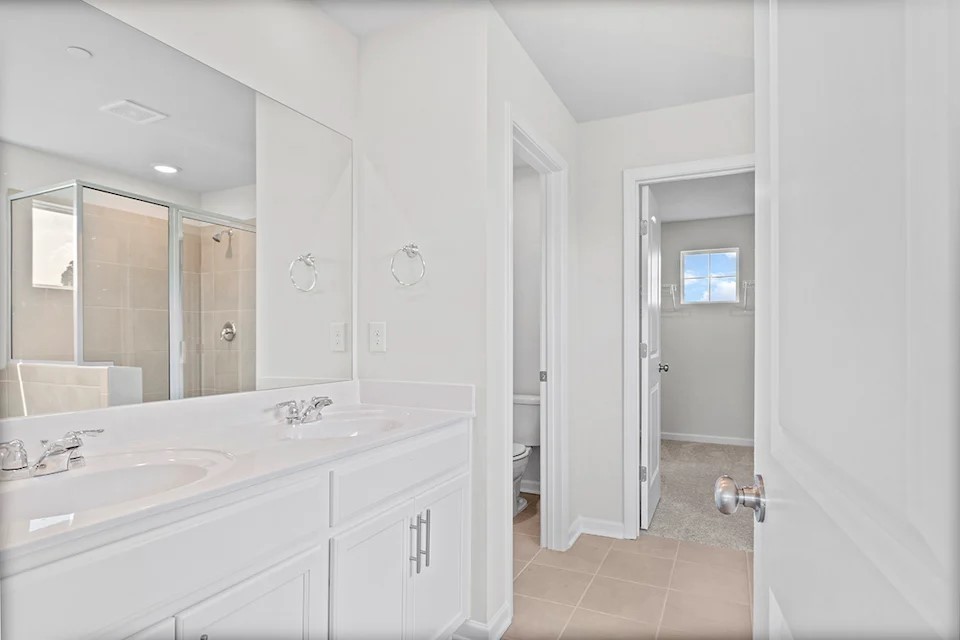 2456 Beverly Gail Road Pleasant View, TN 37146 - Photo 29 of 38 a bathroom with a double vanity sink and mirror