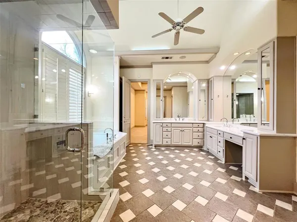 a large bathroom with a sink a mirror and a shower