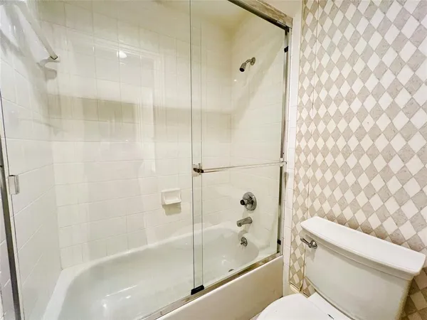 a bathroom with a shower and a toilet