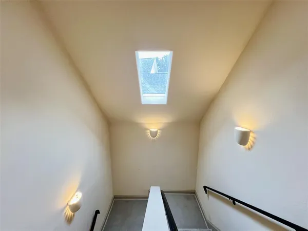 a view of an empty room and wooden floor