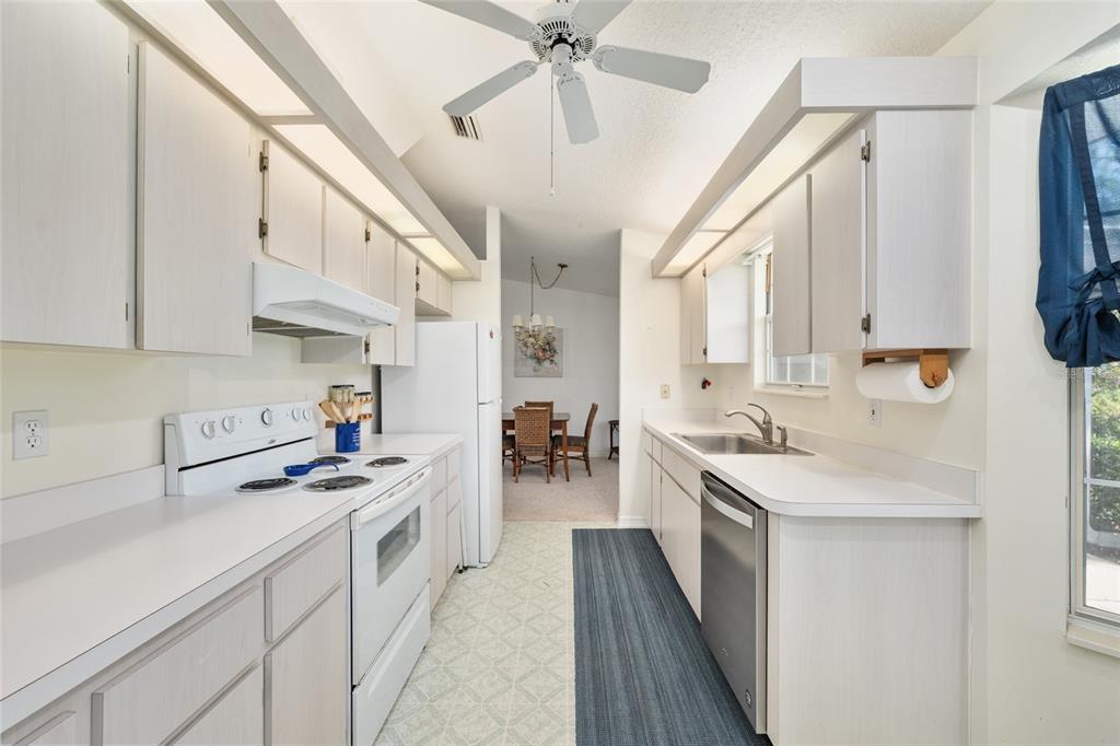 8038 Southwest 108th Loop Ocala, FL 34481 - Photo 15 of 48 a kitchen with a sink stove and cabinets