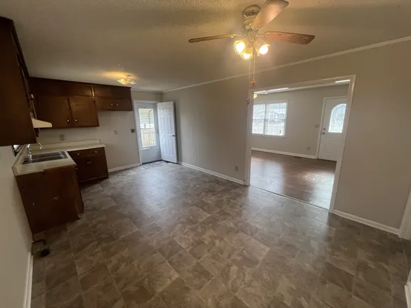 a view of a kitchen with a sink dishwasher and a fireplace