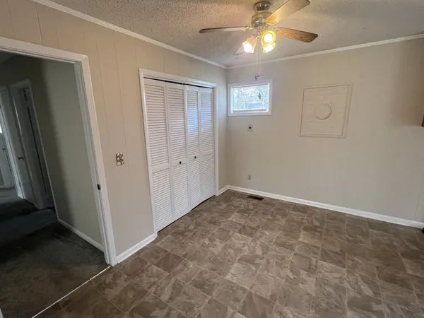 an empty room with closet area