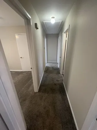 an entryway door with a hallway in the house